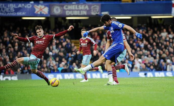 Diego Costa of Chelsea scores his goal to make it to make it 2-0 - Barclays Premier League - Chelsea vs West Ham United - Stamford Bridge Stadium - London - England - 26th December 2014 - Pic Robin Parker Sportimage EDITORIAL USE ONLY. No use with unauthorised audio, video, data, fixture lists, club league logos or live services. Online in-match use limited to 120 images, no video emulation. No use in betting, games or single club league player publications. DSC_3038.JPG