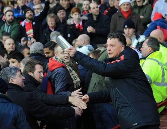 Manchester United ManU s Louis Van Gaal gives out presents to the crowd Barclays Premier League - Manchester United vs Newcastle United - Old Trafford - England - 26th December 2014 - Picture David Klein Sportimage EDITORIAL USE ONLY. No use with unauthorised audio, video, data, fixture lists, club league logos or live services. Online in-match use limited to 120 images, no video emulation. No use in betting, games or single club league player publications.