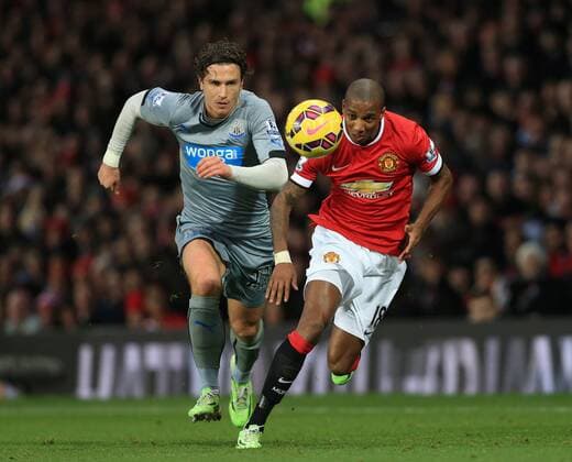 Manchester United ManU s Ashley Young tussles with Newcastle s Daryl Janmaat Barclays Premier League - Manchester United vs Newcastle United - Old Trafford - England - 26th December 2014 - Picture David Klein Sportimage EDITORIAL USE ONLY. No use with unauthorised audio, video, data, fixture lists, club league logos or live services. Online in-match use limited to 120 images, no video emulation. No use in betting, games or single club league player publications.