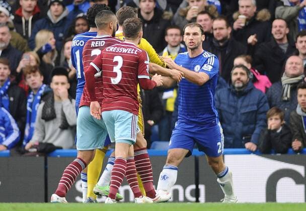 Football - 2014 2015 Premier League - Chelsea vs. West Ham United Chelsea s Branislav Ivanovic is challenged by West ham players, accusing him of diving at Stamford Bridge. COLORSPORT ANDREW COWIE
