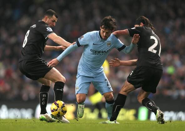 David Silva of Manchester City tries to weave whiskey past Dean Marney and George Boyd of Burnley - Barclays Premier League - Manchester City vs Burnley FC - Etihad Stadium - Manchester - England - 28th December 2014 - Picture Simon Bellis Sportimage EDITORIAL USE ONLY. No use with unauthorised audio, video, data, fixture lists, club league logos or live services. Online in-match use limited to 120 images, no video emulation. No use in betting, games or single club league player publications.