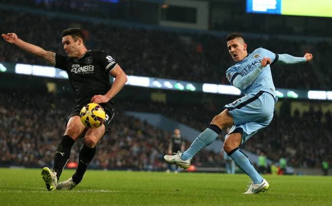 Stevan Jovetic of Manchester City fires in a volley which is blocked by Jason Shackell of Burnley - Barclays Premier League - Manchester City vs Burnley FC - Etihad Stadium - Manchester - England - 28th December 2014 - Picture Simon Bellis Sportimage EDITORIAL USE ONLY. No use with unauthorised audio, video, data, fixture lists, club league logos or live services. Online in-match use limited to 120 images, no video emulation. No use in betting, games or single club league player publications.