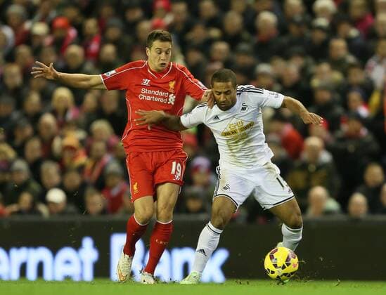 Javi Manquillo of FC Liverpool tackles Wayne Routledge of Swansea City - Barclays Premier League - FC Liverpool vs Swansea City - Anfield Stadium - Liverpool - England - 29th December 2014 - EDITORIAL USE ONLY. No use with unauthorised audio, video, data, fixture lists, club league logos or live services. Online in-match use limited to 120 images, no video emulation. No use in betting, games or single club league player publications.