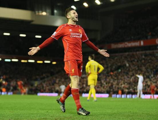 Adam Lallana of FC Liverpool celebrates after chasing down a back pass to score from the attempted clearance by Lucas Fabianski of Swansea City - Barclays Premier League - FC Liverpool vs Swansea City - Anfield Stadium - Liverpool - England - 29th December 2014 - EDITORIAL USE ONLY. No use with unauthorised audio, video, data, fixture lists, club league logos or live services. Online in-match use limited to 120 images, no video emulation. No use in betting, games or single club league player publications.