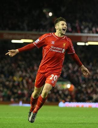 Adam Lallana of FC Liverpool celebrates after chasing down a back pass to score from the attempted clearance by Lucas Fabianski of Swansea City - Barclays Premier League - FC Liverpool vs Swansea City - Anfield Stadium - Liverpool - England - 29th December 2014 - EDITORIAL USE ONLY. No use with unauthorised audio, video, data, fixture lists, club league logos or live services. Online in-match use limited to 120 images, no video emulation. No use in betting, games or single club league player publications.