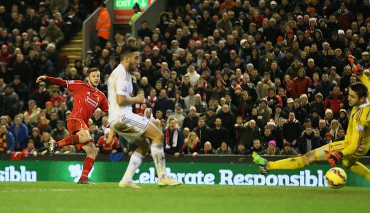 Adam Lallana of FC Liverpool scores the third goal past Lucas Fabianski of Swansea City - Barclays Premier League - FC Liverpool vs Swansea City - Anfield Stadium - Liverpool - England - 29th December 2014 - EDITORIAL USE ONLY. No use with unauthorised audio, video, data, fixture lists, club league logos or live services. Online in-match use limited to 120 images, no video emulation. No use in betting, games or single club league player publications.