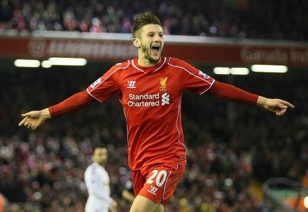 Adam Lallana of FC Liverpool celebrates after chasing down a back pass to score from the attempted clearance by Lucas Fabianski of Swansea City - Barclays Premier League - FC Liverpool vs Swansea City - Anfield Stadium - Liverpool - England - 29th December 2014 - EDITORIAL USE ONLY. No use with unauthorised audio, video, data, fixture lists, club league logos or live services. Online in-match use limited to 120 images, no video emulation. No use in betting, games or single club league player publications.