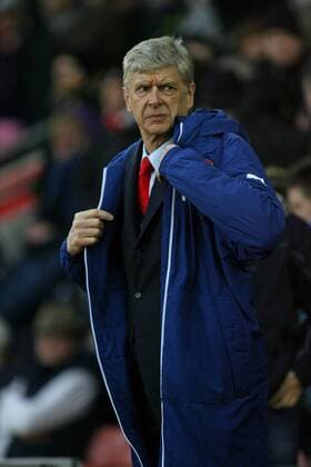 Football - 2014 2015 Premier League - Southampton vs. Arsenal Time for your coat, Arsenal Manager Arsene Wenger puts his coat on as it gets cold at St Mary s Stadium Southampton Colorsport Shaun Boggust 