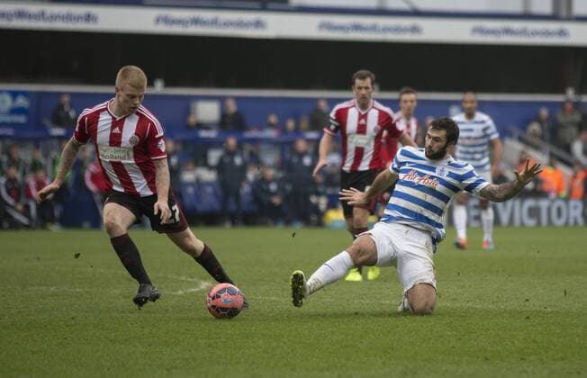 04.01.2015. London, England. FA Cup 3rd Round. QPR versus Sheffield United. QPR s Charlie Austin slides in to win the ball against Sheffield United s Terry Kennedy. xNigelxCookex  ActionPlus11586705