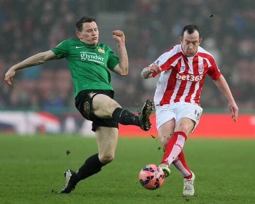 Connor Jennings of Wrexham tackles Charlie Adams of Stoke City - FA Cup Third Round - Stoke City vs Wrexham - Britannia Stadium - Stoke on Trent - England - 4th January 2015 - Picture Simon Bellis Sportimage EDITORIAL USE ONLY. No use with unauthorised audio, video, data, fixture lists, club league logos or live services. Online in-match use limited to 120 images, no video emulation. No use in betting, games or single club league player publications.