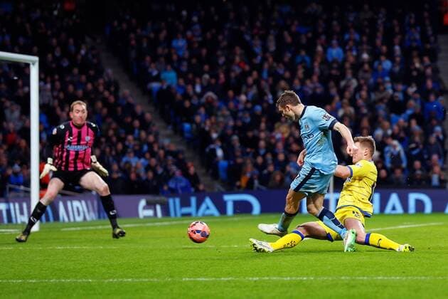04.01.2015. Manchester, England. FA Cup 3rd Round. Manchester City versus Sheffield Wednesday. Manchester City midfielder James Milner scores past Sheffield Wednesday goalkeeper Chris Kirkland for the equalizing goal 1-1 xPaulxKeevilx  ActionPlus11586876