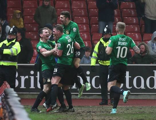 Mark Carrington of Wrexham is mobbed after scoring the opening goal - FA Cup Third Round - Stoke City vs Wrexham - Britannia Stadium - Stoke on Trent - England - 4th January 2015 - Picture Simon Bellis Sportimage EDITORIAL USE ONLY. No use with unauthorised audio, video, data, fixture lists, club league logos or live services. Online in-match use limited to 120 images, no video emulation. No use in betting, games or single club league player publications.