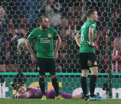 Jon Platt, Neil Ashton and Joe Clarke of Wrexham dejected as Stoke players celebrate- FA Cup Third Round - Stoke City vs Wrexham - Britannia Stadium - Stoke on Trent - England - 4th January 2015 - Picture Simon Bellis Sportimage EDITORIAL USE ONLY. No use with unauthorised audio, video, data, fixture lists, club league logos or live services. Online in-match use limited to 120 images, no video emulation. No use in betting, games or single club league player publications.