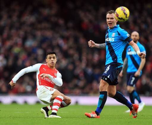 Arsenal s Alexis Sanchez fires in a shot Premier League - Arsenal vs Stoke City - Emirates Stadium - England - 11th January 2015 - Picture David Klein Sportimage EDITORIAL USE ONLY. No use with unauthorised audio, video, data, fixture lists, club league logos or live services. Online in-match use limited to 120 images, no video emulation. No use in betting, games or single club league player publications.