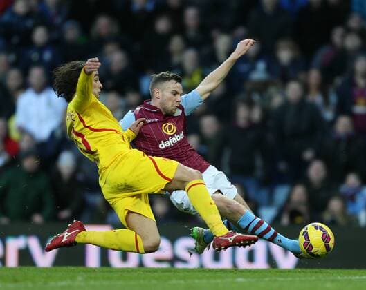 Lazar Markovic of Liverpool tackles Tom Cleverley of Aston Villa - Barclays Premier League - Aston Villa vs Liverpool - Villa Park Stadium - Birmingham - England - 17th January 2015 - Picture Simon Bellis Sportimage EDITORIAL USE ONLY. No use with unauthorised audio, video, data, fixture lists, club league logos or live services. Online in-match use limited to 120 images, no video emulation. No use in betting, games or single club league player publications.