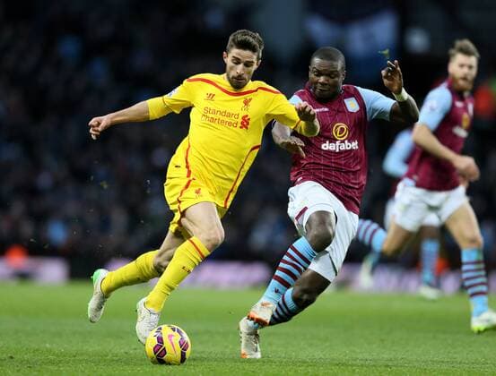 Fabio Borini of Liverpool tussles with Jores Okore of Aston Villa- Barclays Premier League - Aston Villa vs Liverpool - Villa Park Stadium - Birmingham - England - 17th January 2015 - Picture Simon Bellis Sportimage EDITORIAL USE ONLY. No use with unauthorised audio, video, data, fixture lists, club league logos or live services. Online in-match use limited to 120 images, no video emulation. No use in betting, games or single club league player publications.