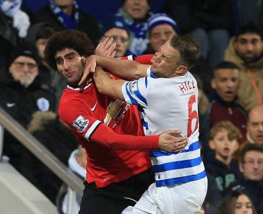 QPR s Clint Hill tussles with Manchester United ManU s Marouane Fellaini Barclays Premier League - Queens Park Rangers vs Manchester United - Loftus Road - England - 17th January 2015 - Picture David Klein Sportimage EDITORIAL USE ONLY. No use with unauthorised audio, video, data, fixture lists, club league logos or live services. Online in-match use limited to 120 images, no video emulation. No use in betting, games or single club league player publications.