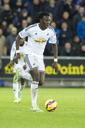 Football - 2014 2015 Premier League - Swansea City vs. Chelsea Bafétimbi Gomis of Swansea attacks at The Liberty Stadium. COLORSPORT WINSTON BYNORTH