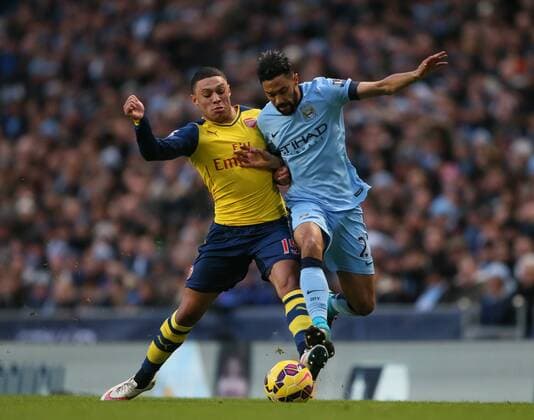 Alex Oxlade-Chamberlain of Arsenal tussles with Gael Clichy of Manchester City - Barclays Premier League - Manchester City vs Arsenal - Etihad Stadium - Manchester - England - 18th January 2015 - Picture Simon Bellis Sportimage EDITORIAL USE ONLY. No use with unauthorised audio, video, data, fixture lists, club league logos or live services. Online in-match use limited to 120 images, no video emulation. No use in betting, games or single club league player publications.