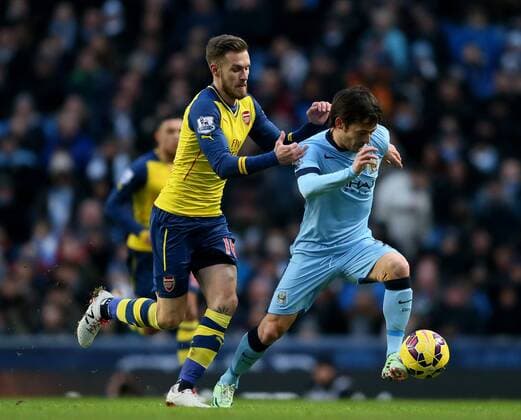 Aaron Ramsey of Arsenal tackles David Silva of Manchester City - Barclays Premier League - Manchester City vs Arsenal - Etihad Stadium - Manchester - England - 18th January 2015 - Picture Simon Bellis Sportimage EDITORIAL USE ONLY. No use with unauthorised audio, video, data, fixture lists, club league logos or live services. Online in-match use limited to 120 images, no video emulation. No use in betting, games or single club league player publications.