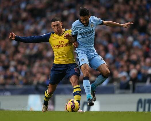 Alex Oxlade-Chamberlain of Arsenal tussles with Gael Clichy of Manchester City - Barclays Premier League - Manchester City vs Arsenal - Etihad Stadium - Manchester - England - 18th January 2015 - Picture Simon Bellis Sportimage EDITORIAL USE ONLY. No use with unauthorised audio, video, data, fixture lists, club league logos or live services. Online in-match use limited to 120 images, no video emulation. No use in betting, games or single club league player publications.