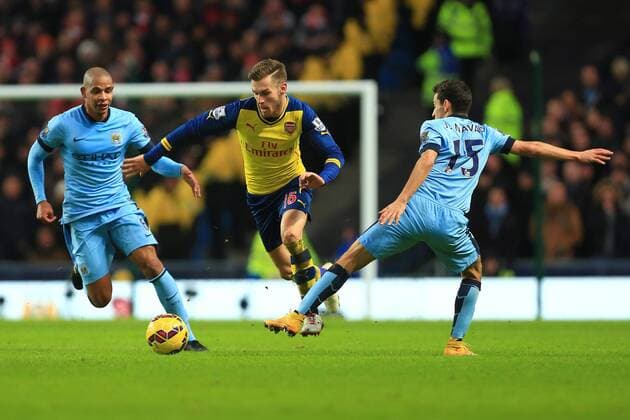 Arsenal s Aaron Ramsey skips past Jesus Navas of Manchester City - Manchester City vs. Arsenal - Barclay s Premier League - Etihad Stadium - Manchester - 18 01 2015 Pic Philip Oldham Sportimage EDITORIAL USE ONLY. No use with unauthorised audio, video, data, fixture lists, club league logos or live services. Online in-match use limited to 120 images, no video emulation. No use in betting, games or single club league player publications.