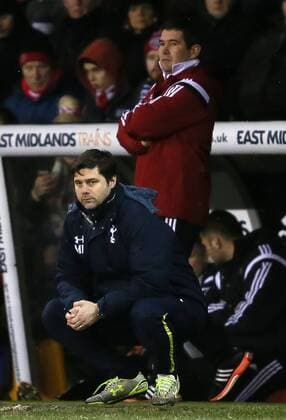 Nigel Clough manager of Sheffield Utd stands behind Mauricio Pochettino manager of Tottenham crouched at the side of the pitch - League Cup Semi Final Second Leg - Sheffield Utd vs Tottenham - Bramall Lane Stadium - Sheffield - England - 28th January 2015 - Picture Simon Bellis Sportimage EDITORIAL USE ONLY. No use with unauthorised audio, video, data, fixture lists, club league logos or live services. Online in-match use limited to 120 images, no video emulation. No use in betting, games or single club league player publications.
