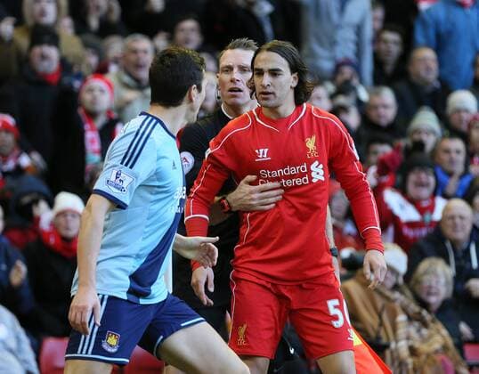 The assistant referee steps in between Stewart Downing of West Ham United and Lazar Markovic of FC Liverpool - Barclays Premier League - FC Liverpool vs West Ham United - Anfield Stadium - Liverpool - England - 31st January 2015 - EDITORIAL USE ONLY. No use with unauthorised audio, video, data, fixture lists, club league logos or live services. Online in-match use limited to 120 images, no video emulation. No use in betting, games or single club league player publications.
