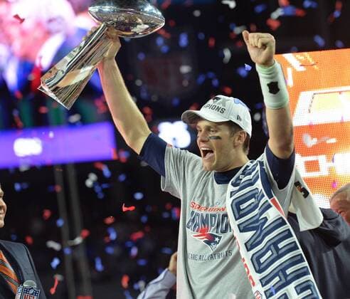 New England Patriots Tom Brady holds up the Vince Lombardi Trophy next to Head Coach Bill Belichick (R) after defeating the Seattle Seahawks 28-24 to winn Super Bowl XLIX at University of Phoenix Stadium in Glendale, Arizona, February 1, 2015.  SBP20150201100 KEVINxDIETSCH