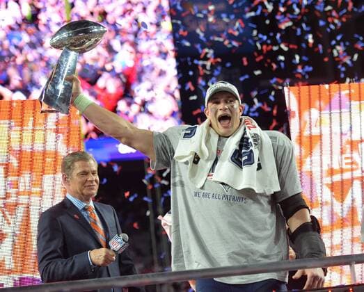 New England Patriots TE Rob Gronkowski folds up the Vince Lombardi Trophy after the Patriots defeated the Seattle Seahawks 28-24 to win Super Bowl XLIX at University of Phoenix Stadium in Glendale, Arizona, February 1, 2015.  SBP20150201107 KEVINxDIETSCH