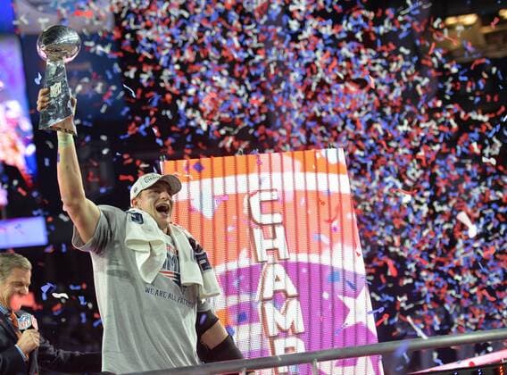 New England Patriots TE Rob Gronkowski folds up the Vince Lombardi Trophy after the Patriots defeated the Seattle Seahawks 28-24 to win Super Bowl XLIX at University of Phoenix Stadium in Glendale, Arizona, February 1, 2015.  SBP20150201117 KEVINxDIETSCH