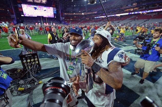 New England Patriots celebrate with the Vince Lombardi Trophy after the Patriots defeated the Seattle Seahawks 28-24 to win Super Bowl XLIX at University of Phoenix Stadium in Glendale, Arizona, February 1, 2015.  SBP20150201121 KEVINxDIETSCH