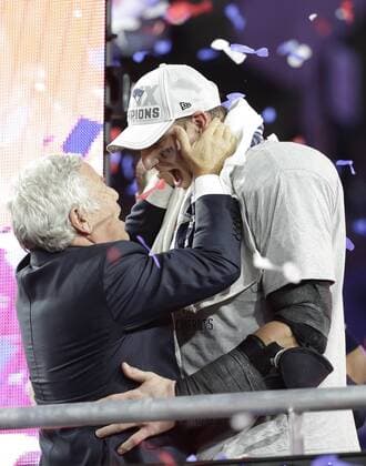 New England Patriots owner Robert Kraft (L) hugs Patriots tight end Rob Gronkowski on the victory podium at Super Bowl XLIX at University of Phoenix Stadium in Glendale, Arizona, February 1, 2015. New England beat Seattle 28-24 to win the Lombardi trophy and Super Bowl XLIX.  SBP20150201364 JOHNxANGELILLO
