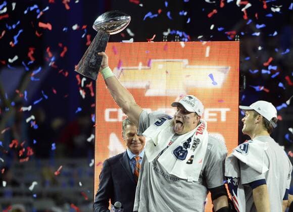 New England Patriots tight end Rob Gronkowski (87) sticks out his tongue as he celebrates his MVP with quarterback Tom Brady (R) after their 28-24 win over the Seattle Seahawks in Super Bowl XLIX at University of Phoenix Stadium in Glendale, Arizona, February 1, 2015.  SBP20150201666 DAVIDxTULIS