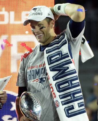 New England Patriots quarterback Tom Brady (12) smiles after he receives the Vince Lombardi Trophy and an MVP in their 28-24 win over the Seattle Seahawks during Super Bowl XLIX at University of Phoenix Stadium in Glendale, Arizona, February 1, 2015.  SBP20150201667 DAVIDxTULIS