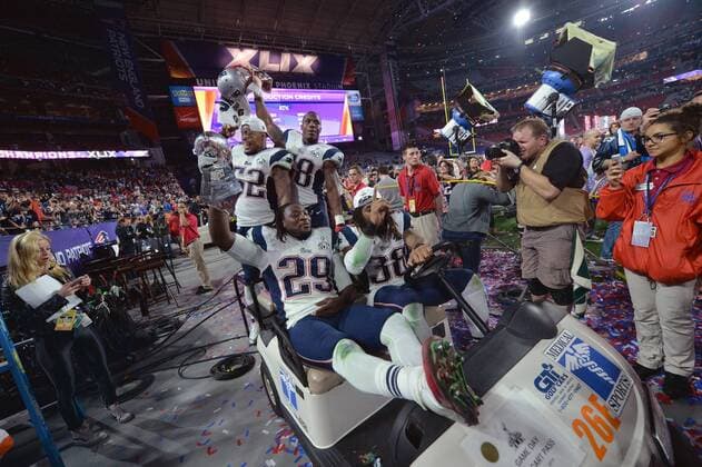 New England Patriots Le Garrette Blount (29), Brandon Bolden (38), Jonathan Casilas (52), and Darius Fleming (58) celebrate with the Vince Lombardi Trophy after the Patriots defeated the Seattle Seahawks 28-24 to win Super Bowl XLIX at University of Phoenix Stadium in Glendale, Arizona, February 1, 2015.  SBP20150201997 KEVINxDIETSCH