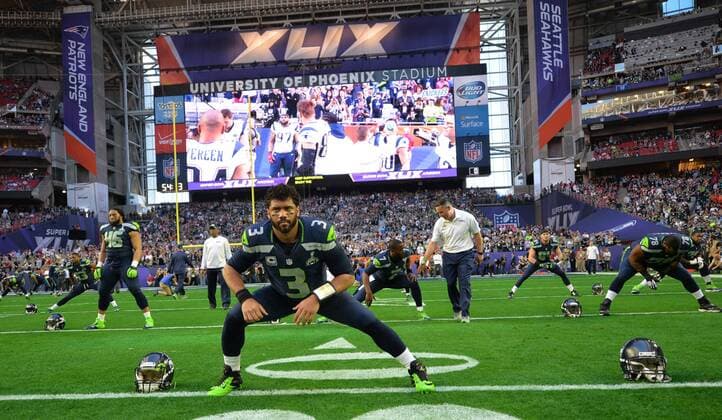 Seattle Seahawks quarterback Russell Wilson (3) stretches before playing the New England Patriots in the first quarter of Super Bowl XLIX at University of Phoenix Stadium in Glendale, Arizona, February 1, 2015.  SBP20150201030 KEVINxDIETSCH