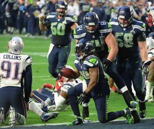 Seattle Seahawks Marshawn Lynch (24) is congratulated after a three yard TD against the New England Patriots in the second quarter of Super Bowl XLIX at University of Phoenix Stadium in Glendale, Arizona, February 1, 2015.  SBP20150201051 PATxBENIC