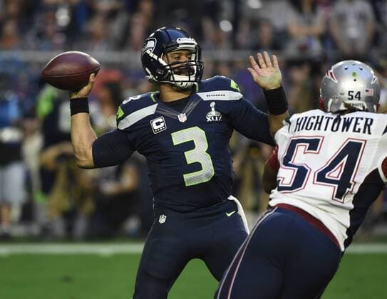 Seattle Seahawks quarterback Russell Wilson looks to pass against the New England Patriots in the second quarter of Super Bowl XLIX at University of Phoenix Stadium in Glendale, Arizona, February 1, 2015.  SBP20150201072 KEVINxDIETSCH