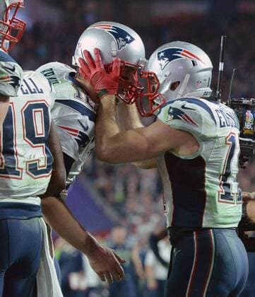 New England Patriots Julian Edelman is congratulated by Tom Brady (L) after catching a pass for a three yard TD against the Seattle Seahawks in the fourth quarter of Super Bowl XLIX at University of Phoenix Stadium in Glendale, Arizona, February 1, 2015. The Patriots defeated the Seahawks 28-24.  SBP20150201090 KEVINxDIETSCH