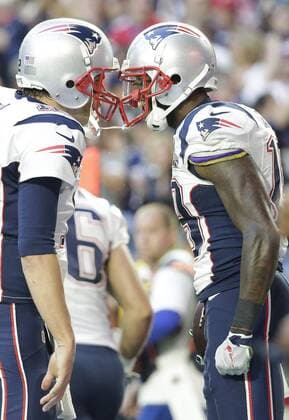 New England Patriots quarterback Tom Brady (L) celebrates with wide receiver Brandon LaFell (R) after his 11-yard touchdown pass reception against the Seattle Seahawks in the second quarter of Super Bowl XLIX at University of Phoenix Stadium in Glendale, Arizona, February 1, 2015.  SBP20150201329 JOHNxANGELILLO
