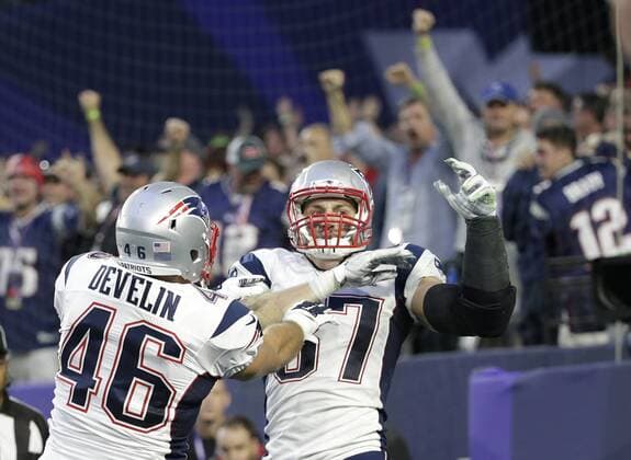 New England Patriots tight end Rob Gronkowski (R) celebrates his 22-yard touchdown reception against the Seattle Seahawks with teammate James Develin during the second quarter of Super Bowl XLIX at University of Phoenix Stadium in Glendale, Arizona, February 1, 2015.  SBP20150201343 JOHNxANGELILLO