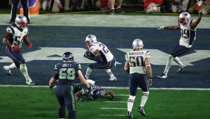 New England Patriots cornerback Malcolm Butler (C) makes a game saving interception against the Seattle Seahawks late in the fourth quarter of Super Bowl XLIX at University of Phoenix Stadium in Glendale, Arizona, February 1, 2015. New England beat Seattle 28-24 to win the Lombardi trophy.  SBP20150201357 JONxSOOHOO