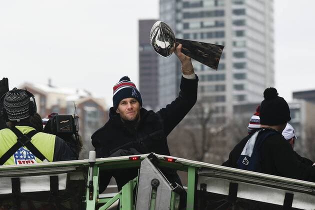 February 4, 2015 - Boston, Massachusetts, U.S. - New England Patriots quarterback Tom Brady (12) hoists the Lombardi Trophy while riding in the back of a duck boat during a parade held in Boston to celebrate the team s victory in Super Bowl XLIX. NFL American Football Herren USA 2015: Patriots Super Bowl Parade FEB 04 - ZUMAc04_