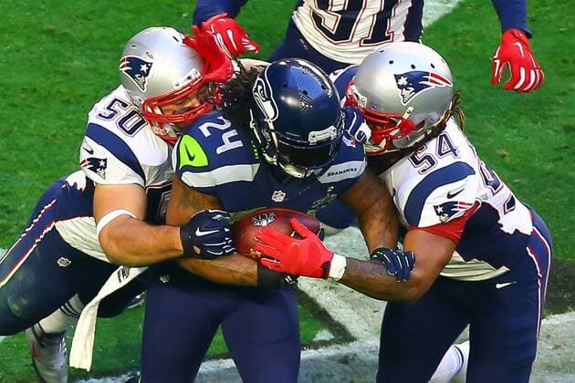 01 FEB 2015: Seattle Seahawks running back Marshawn Lynch (24) gets tackled by New England Patriots defensive end Rob Ninkovich (50) and New England Patriots outside linebacker Dont a Hightower (54) during the first quarter of Super Bowl XLIX being played at University of Phoenix Stadium. The New England Patriots defeat the Seattle Seahawks 28-24 in Super Bowl XLIX at University of Phoenix Stadium in Glendale Arizona. NFL American Football Herren USA FEB 01 Super Bowl XLIX - Patriots v Seahawks Icon020115346 EDITORIAL USE ONLY
