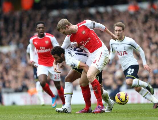 Tottenham s Mousa Dembele tussles with Arsenal s Per Mertesacker Barclays Premier League- Tottenham Hotspurs vs Arsenal - White Hart Lane - England - 7th February 2015 - Picture David Klein Sportimage EDITORIAL USE ONLY. No use with unauthorised audio, video, data, fixture lists, club league logos or live services. Online in-match use limited to 120 images, no video emulation. No use in betting, games or single club league player publications.
