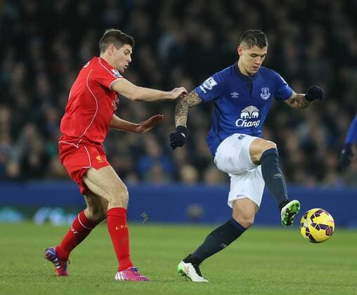 Steven Gerrard of Liverpool challenges Muhamed Besic of Everton - Barclays Premier League - Everton vs Liverpool - Goodison Park Stadium - Liverpool - England - 7th February 2015 - Picture Simon Bellis Sportimage EDITORIAL USE ONLY. No use with unauthorised audio, video, data, fixture lists, club league logos or live services. Online in-match use limited to 120 images, no video emulation. No use in betting, games or single club league player publications.