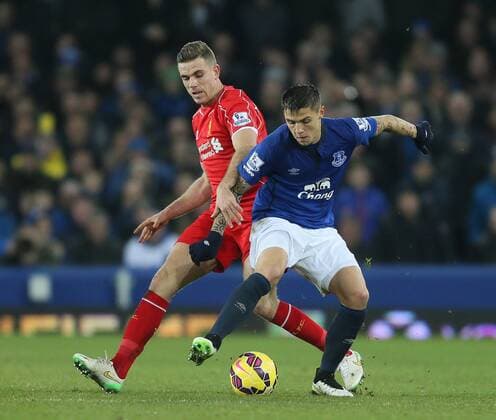 Jordan Henderson of Liverpool challenges Muhamed Besic of Everton - Barclays Premier League - Everton vs Liverpool - Goodison Park Stadium - Liverpool - England - 7th February 2015 - Picture Simon Bellis Sportimage EDITORIAL USE ONLY. No use with unauthorised audio, video, data, fixture lists, club league logos or live services. Online in-match use limited to 120 images, no video emulation. No use in betting, games or single club league player publications.