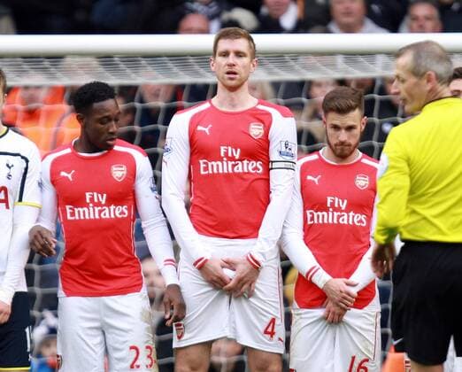 Tottenham Hotspur vs FC Arsenal . . London, UK . . 07.02.15 Eric Dier (TH), Danny Welbeck (A), Per Mertesacker (A), Aaron Ramsey (A) in a defence wall. 