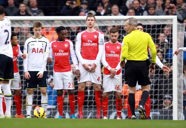 Tottenham Hotspur vs FC Arsenal . . London, UK . . 07.02.15 Eric Dier (TH), Danny Welbeck (A), Per Mertesacker (A), Aaron Ramsey (A) in a defence wall. 